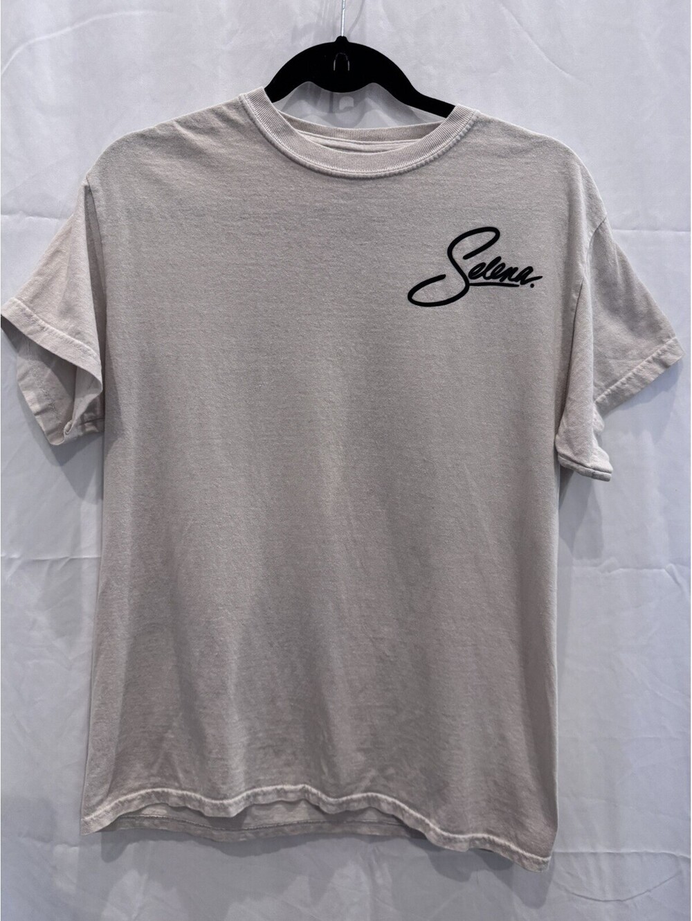 Official Selena merchandise, off-white t-shirt with black cursive 'Selena.' logo